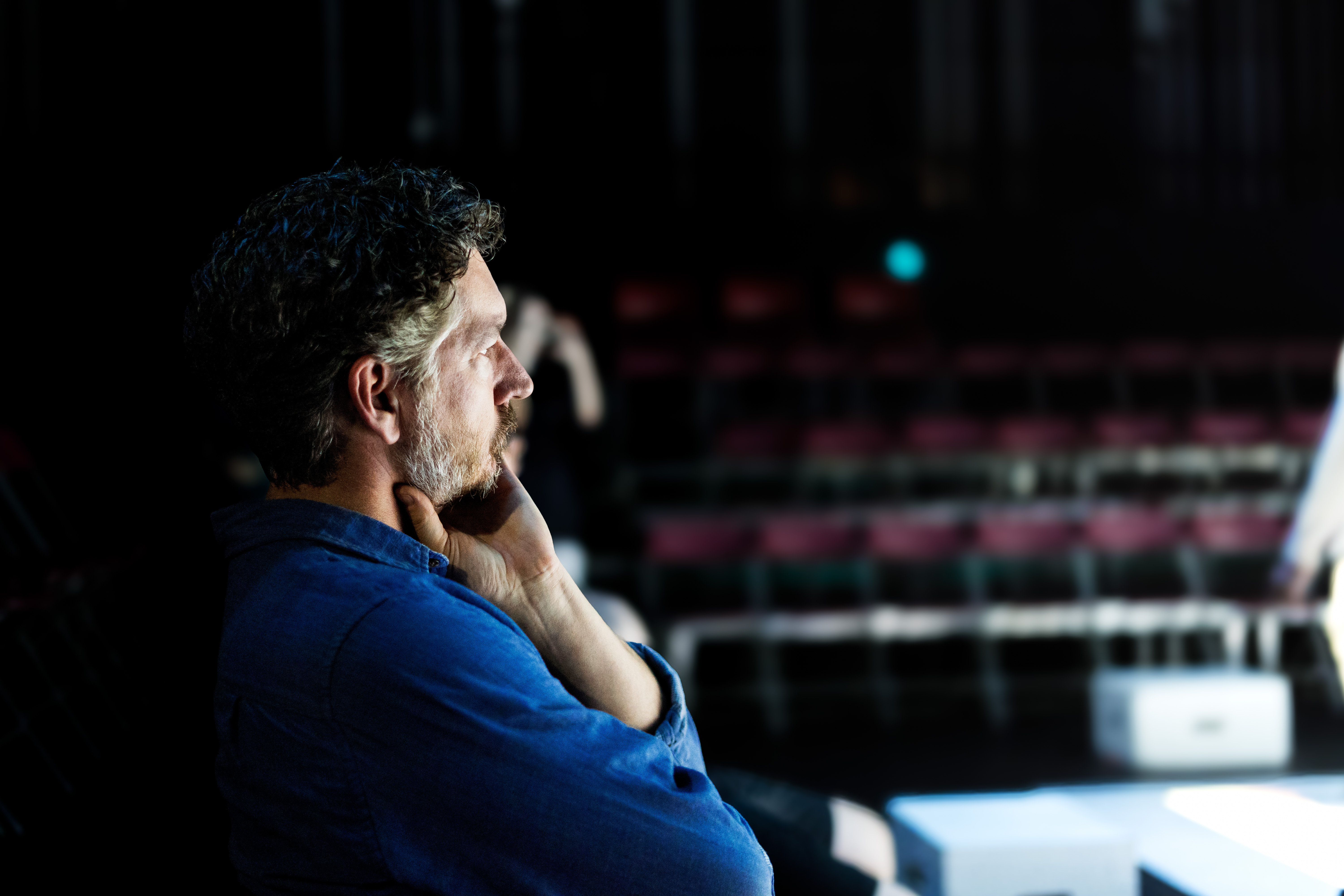 Play director viewing a rehearsal.