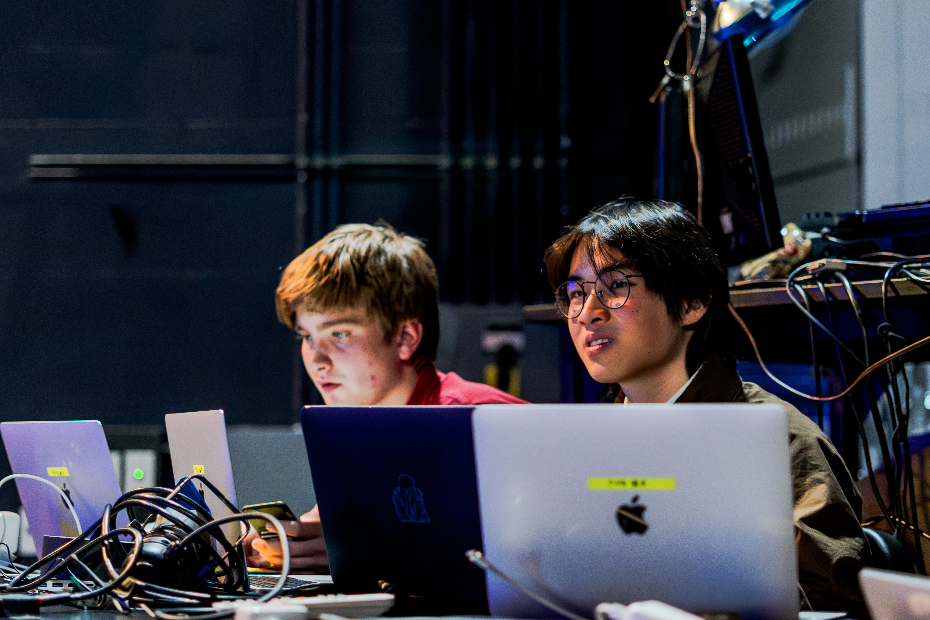Two theatre techs running a show.